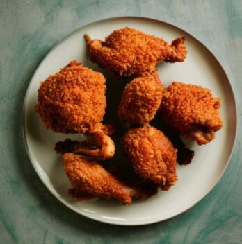 some pieces of Kentucky Fried Chicken thighs on a plate.