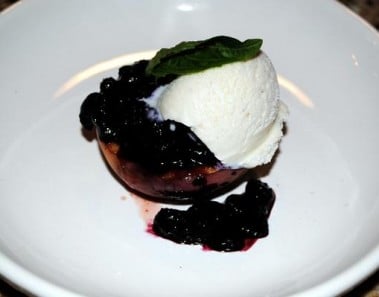 Baked Peaches With Blueberry Sauce and Vanilla Ice Cream