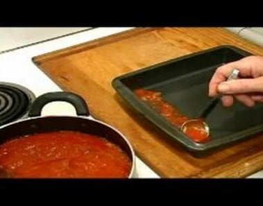 Eggplant Parmesan Recipe : Adding Sauce to Baking Pan for Eggplant Parmesan