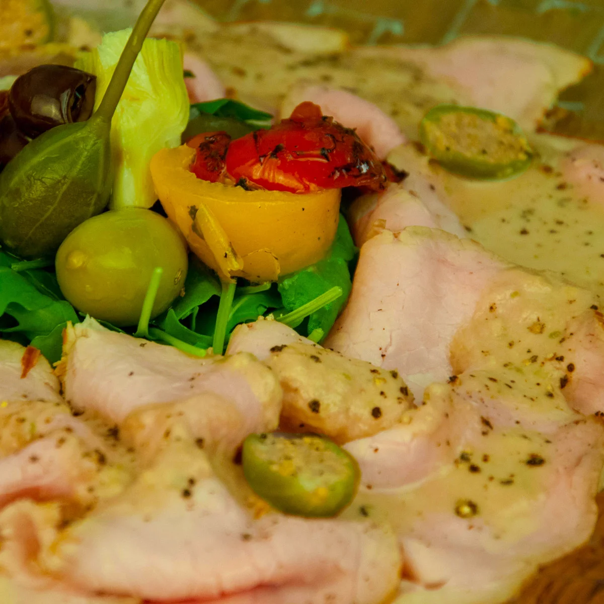 a closeup photo of a plate with vitello tonnato recipe.
