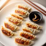 Pan Fried Pork And Chive Potstickers — plated and ready to serve
