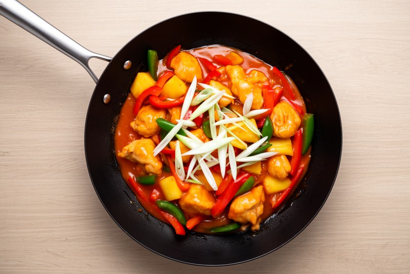Step 5 of making Sweet Sour Pineapple Chicken — Add pineapple chunks briefly