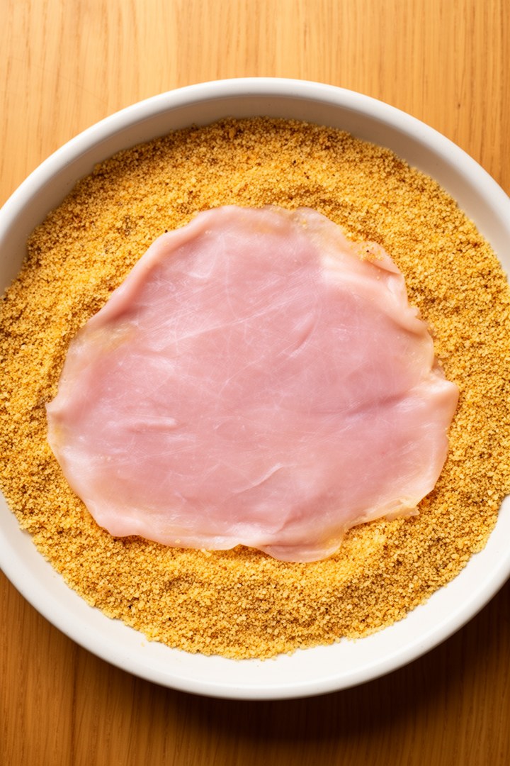 Step 3 of making Wiener Schnitzel Recipe — Lay in breadcrumbs gently